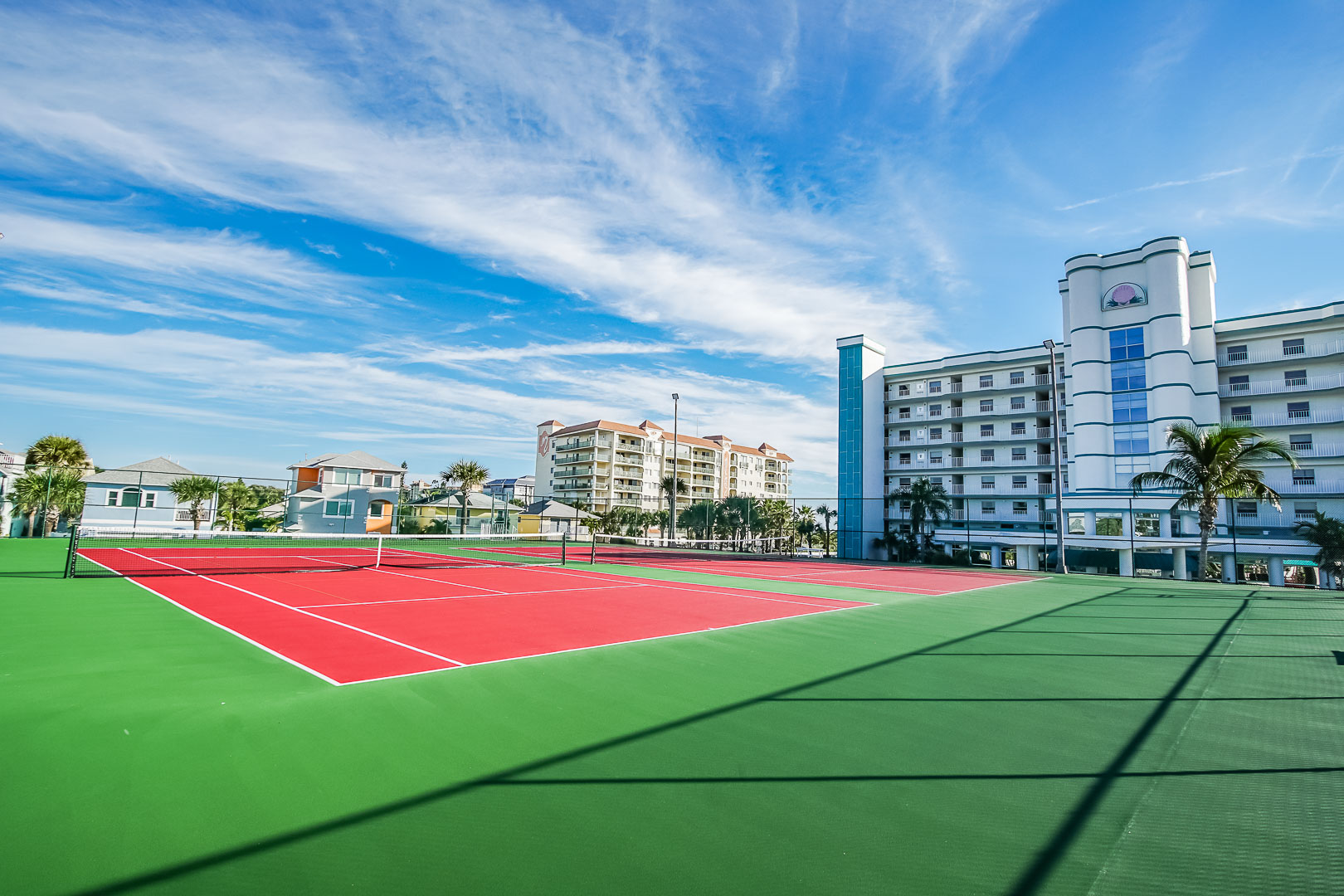 A vibrant outdoor tennis court at VRI's Discovery Beach Resort in Cocoa Beach, Florida.